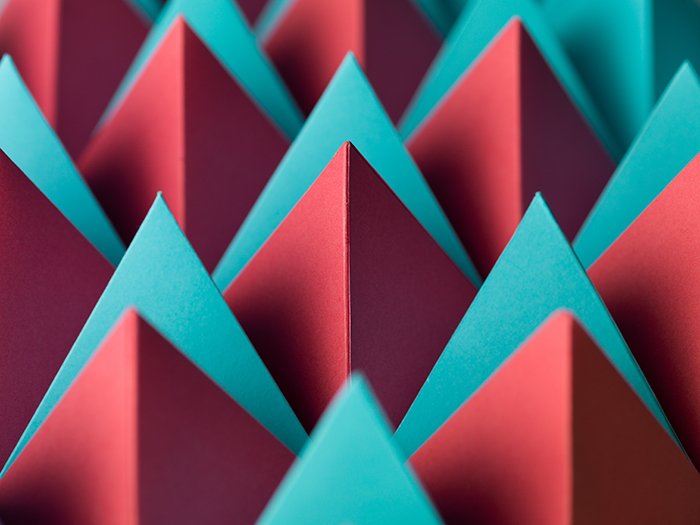 Abstract macro photography with colorful pyramids from paper.