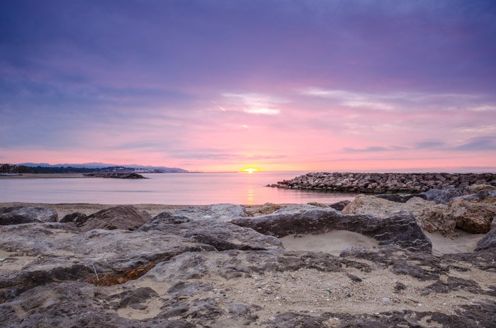 A landscape photo of a seaside at sunset