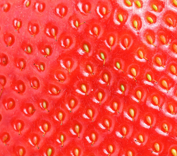 a macro image of a strawberry