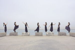 A multiplicity photo of a woman posing in eight different ways on different pillars for creative editing ideas