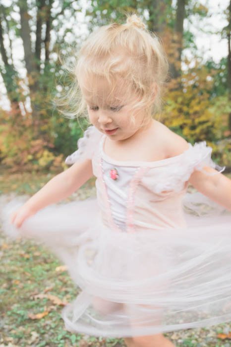 Artistic motion blur photograph of a little girl in a tutu spinning