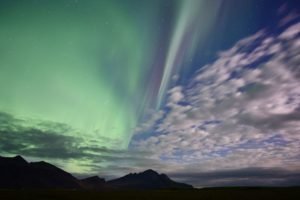 photo of the daytime sky merging into the northern lights