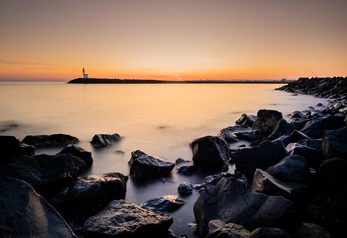 photo of a beach at sunset with long exposure