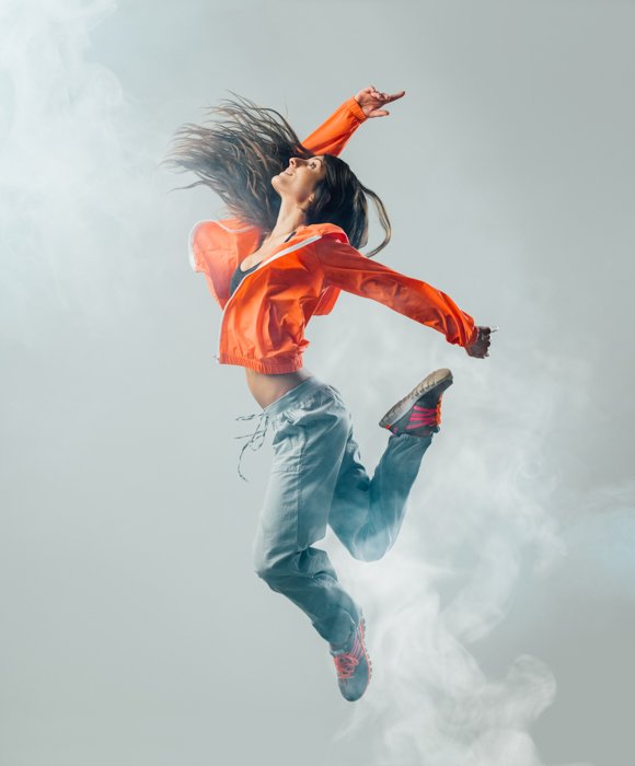 A woman leaping in the air shot with a faster shutter speed