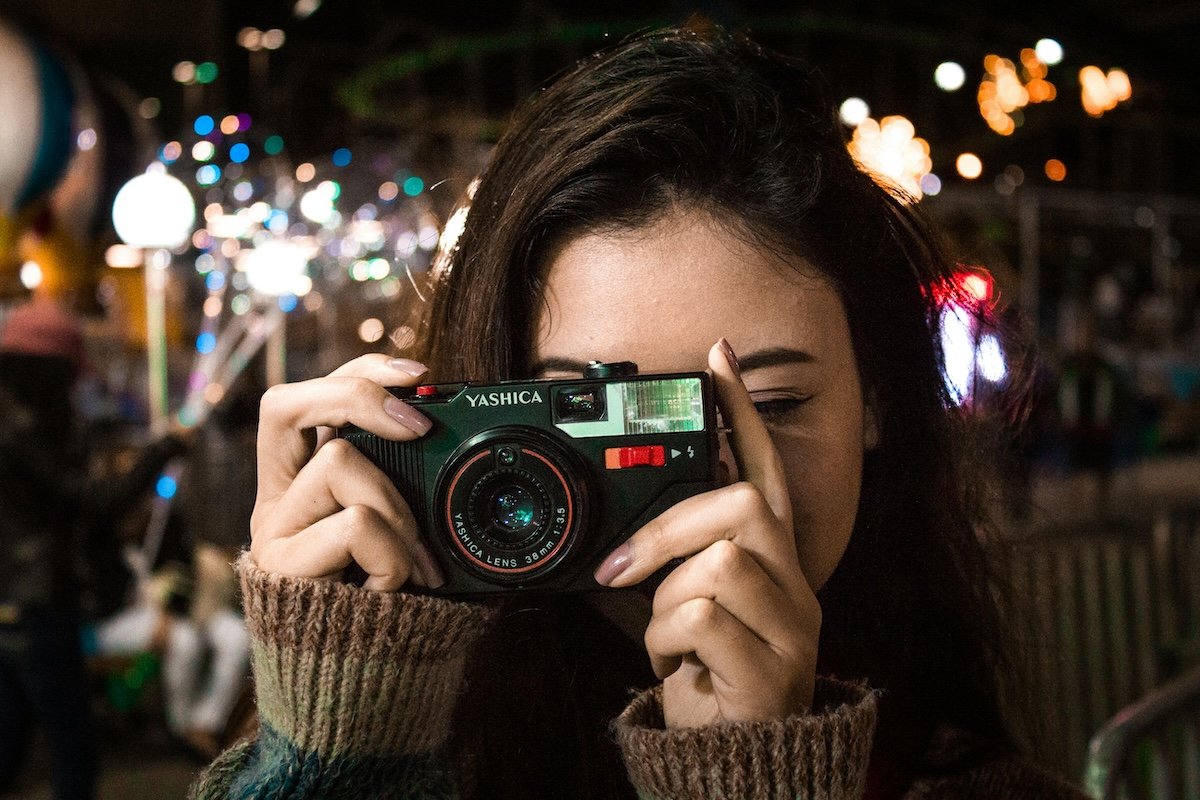 photograph of woman holding a camera