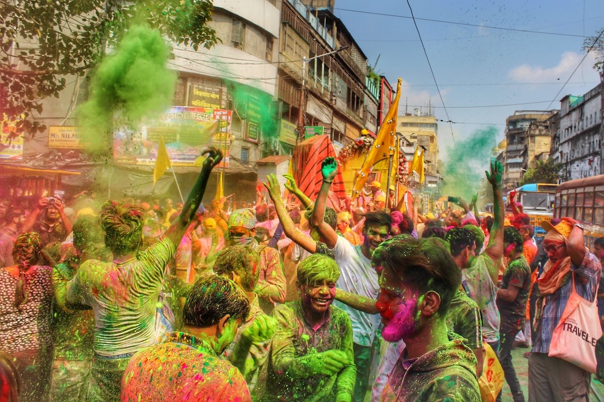 A colorful travel photo of people a the Holi festival in India shot with an APS-C camera