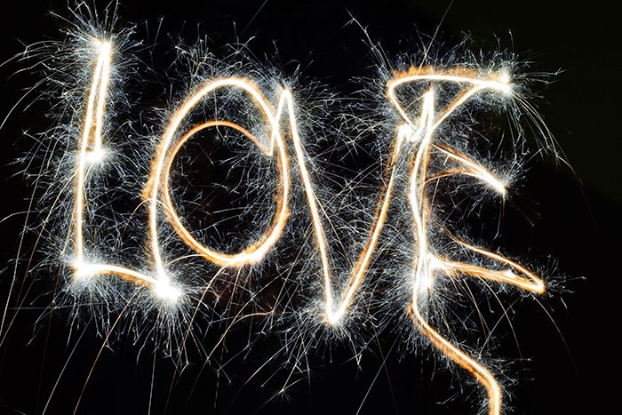 Long exposure light graffiti of the word 'love'.