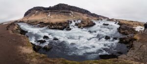 A landscape photo with mountains and rushing river to show how to merge photos in Lightroom