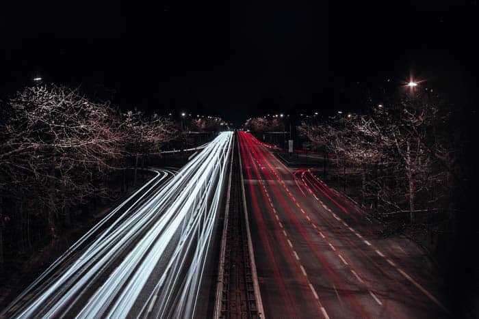 Streaming red and white light trails on a highway shot at f/5.6 for 235 seconds at ISO 100