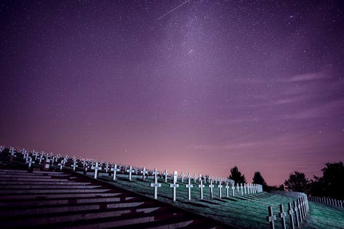 A night photo of a cemetery under a starry sky