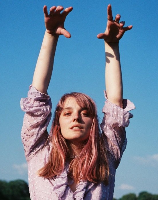 portrait of a girl with her hands in the air