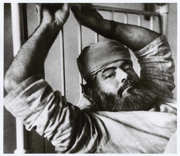 portrait of Ernest Hemingway lying in bed