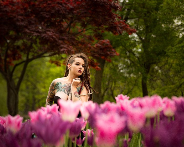 Photo of a woman on a field of pink tulips -shallow depth of field