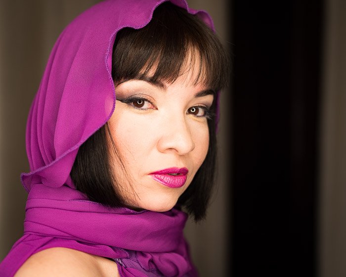 Portrait of a woman with a purple headscarf with shallow depth of field