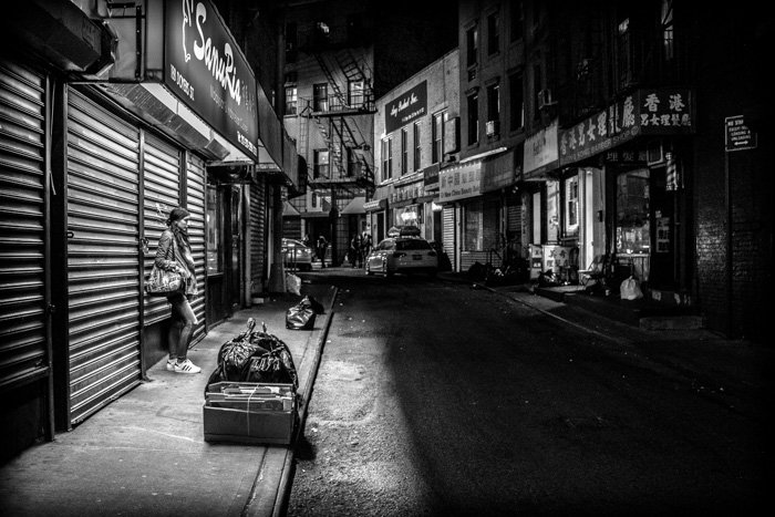 A monotone street scene at night