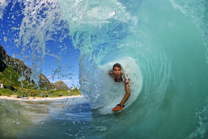 A surfer going through a barrel wave as an example of sports photography