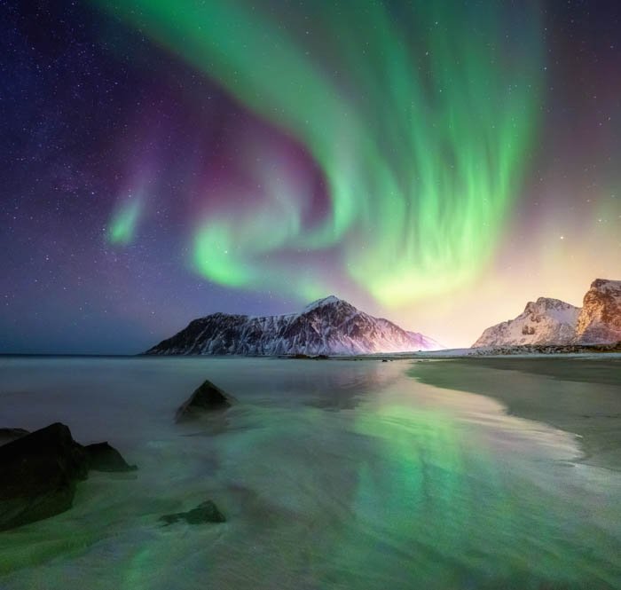 A travel photography image of a beautiful landscape at night with Northern lights